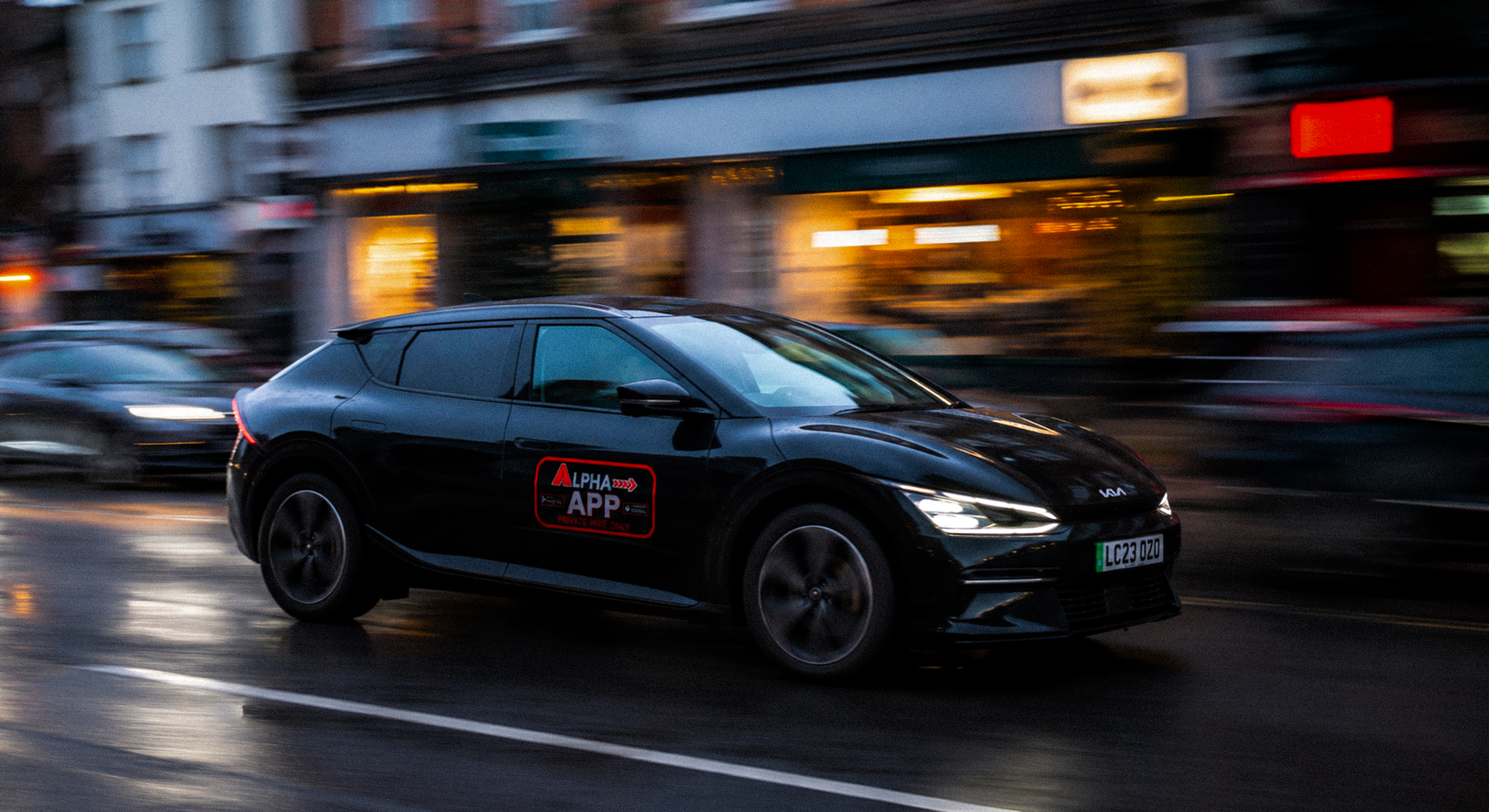 Alpha Taxis electric cab on the move at dusk